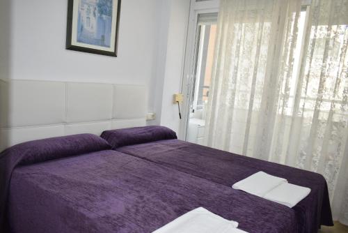 ベニドルムにあるToledo 1 - Fincas Arenaのベッドルーム(紫色のベッド1台、窓付)