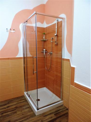 a shower with a glass enclosure in a bathroom at Residenza Belvedere in Orosei