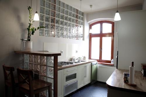 a kitchen with a sink and a stove top oven at Red Bike Old Town in Opole