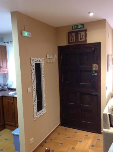 a room with a door and a mirror on the wall at El Mirador de Biedes in Infiesto