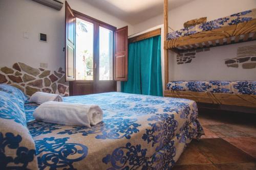 a bedroom with two bunk beds and a window at Villa Di Maria in San Vito lo Capo