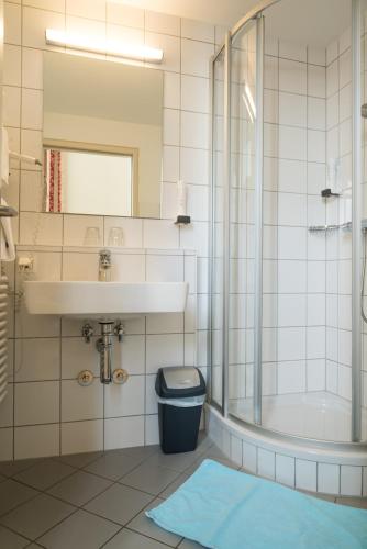 a bathroom with a sink and a toilet and a shower at Gästehaus im Priesterseminar Salzburg in Salzburg