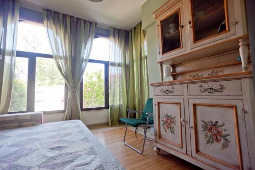 a bedroom with a large dresser and a large window at Casa solare in Bivona