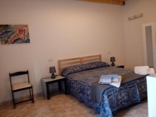 a bedroom with a bed and a chair at B&B La Casetta in Bolognano