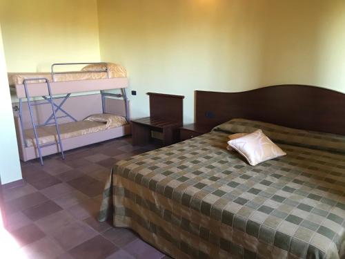 a bedroom with a bed and two bunk beds at Il Podere del Carlone in Vasto