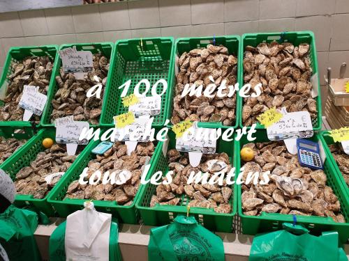a display of different types of nuts in green baskets at Adopt'île in Le Château-dʼOléron