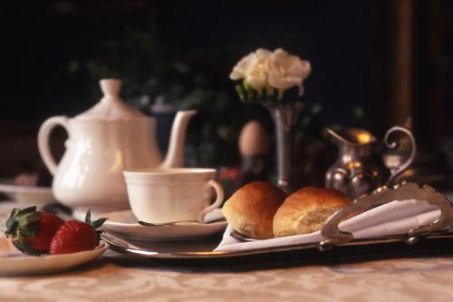 a table with a plate of pastries and a cup of tea at Hotel Maltański in Kraków