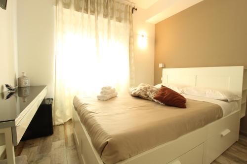 a bedroom with a large bed with a window at Caos Calmo in Rome
