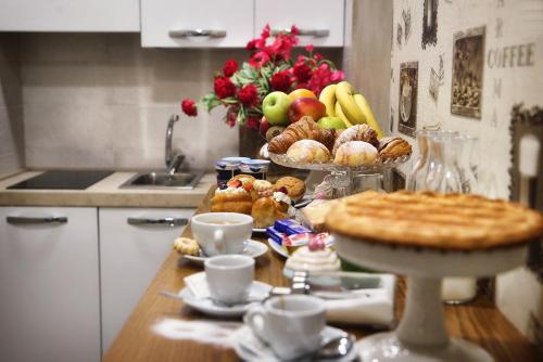 a kitchen with a table with food and a pie at B&B Pompei Olympus in Pompei