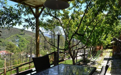 a table and chairs on a balcony with a view of a mountain at Nonno Paco Vacanze in Casarza Ligure