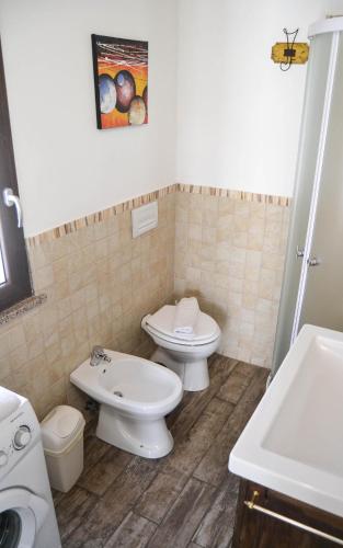 a bathroom with a toilet and a sink at Nonno Paco Vacanze in Casarza Ligure