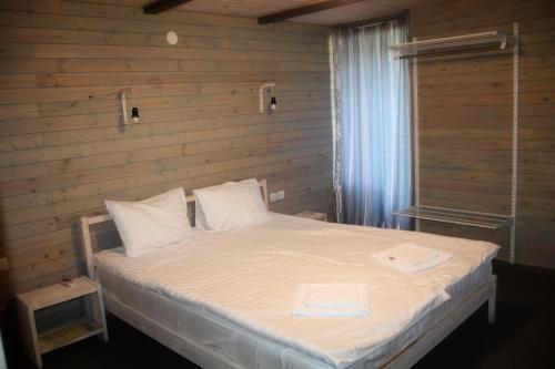 a bedroom with a bed with two towels on it at Эко-комплекс Ахаца in Sukhum
