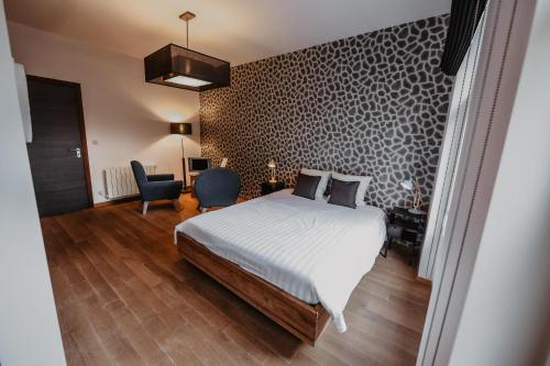 a bedroom with a bed and a desk and a chair at Côté Sax bed and breakfast in Dinant