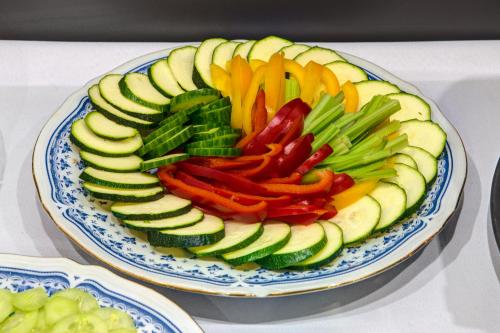a plate of sliced vegetables on a table at Hotel i Restauracja Bona in Sanok