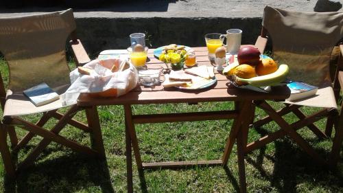 a picnic table with food and drinks and fruit on it at Lithoktisto in Limnionas