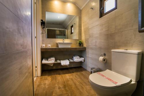 a bathroom with a toilet and a sink at Ask Cozy Rooms in Thessaloniki