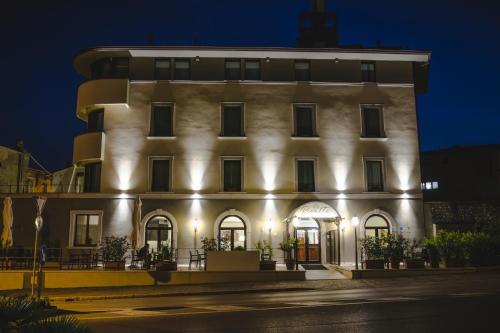 a large building with lights on it at night at Rivalta Life Style Hotel in Salò
