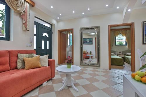 a living room with a red couch and a table at Apartments Holiday Lux in Sutomore