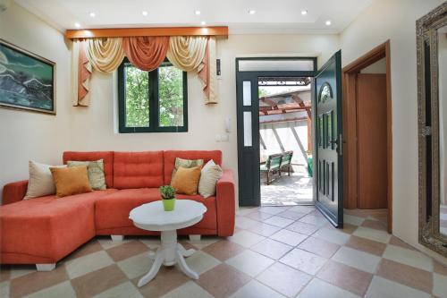 a living room with a red couch and a table at Apartments Holiday Lux in Sutomore