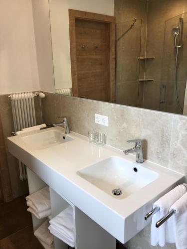 a bathroom with a white sink and a mirror at Haus Werner in Ramsau am Dachstein