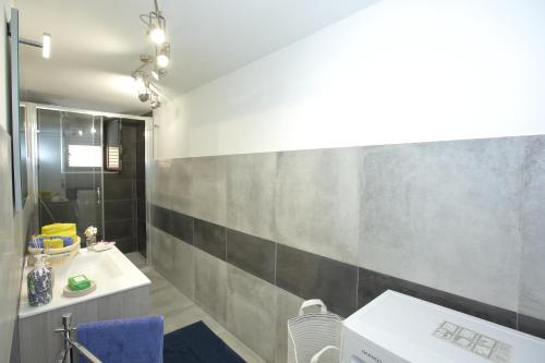a bathroom with a sink and a toilet and a shower at Casa Vignale in Avola