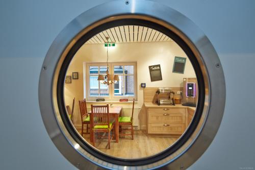 a view of a kitchen and dining room through a mirror at Bernstein-Hotel Bootshaus in Büsum