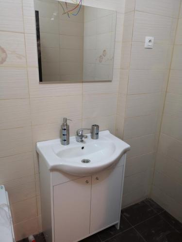 a bathroom with a white sink and a mirror at Casa Alex in Constanţa