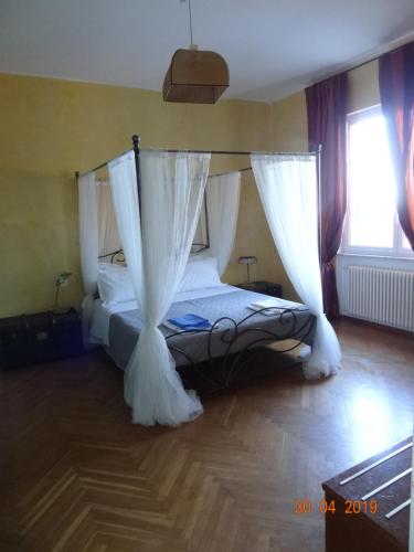 a bedroom with a bed with mosquito nets on it at Bed&BluUp in Savona