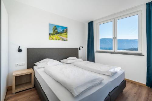 ein Schlafzimmer mit einem großen Bett und einem Fenster in der Unterkunft Residence Alpina in Tisens
