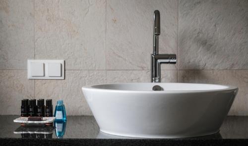 a white sink with a faucet on a counter at Seehotel Europa Resort in Velden am Wörthersee
