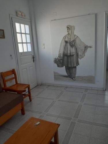 a living room with a drawing of a woman on the wall at Katerina Kafieri Apartments in Firostefani
