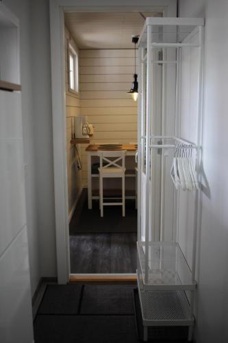 a room with a kitchen with a table and a refrigerator at B&B Lapväärtti in Lapväärtti