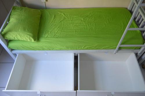 a green pillow on top of a bunk bed at Solar Hostel Beach Copacabana in Rio de Janeiro