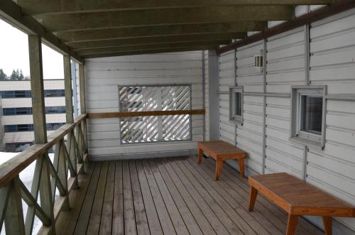 a porch with a bench and a window at Loft Family Hotel in Imatra