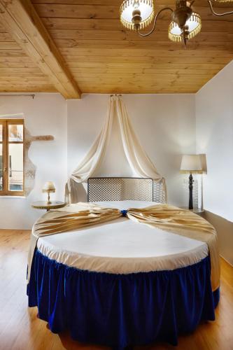 a large bed in a room with a wooden ceiling at Casa Perla Suites in Chania