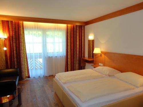 a hotel room with a bed and a window at Business-Hotel Stockinger in Linz