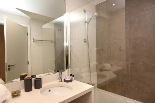 a bathroom with a sink and a shower at Enjoy Lisbon Martim Moniz 1 in Lisbon