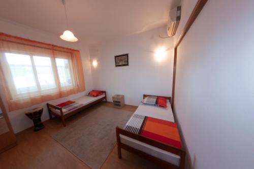 a living room with two beds and a window at Hostel -Sema in Mostar
