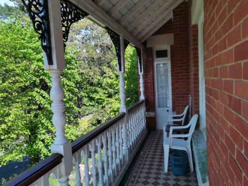a porch of a house with two chairs at Lincoln House in Bournemouth