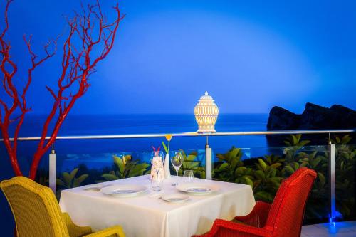 a table with two chairs and a white table cloth at Quattro Passi Relais in Nerano