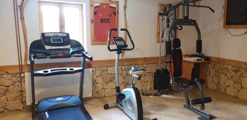 a gym with two exercise bikes and a treadmill at Plitvice Ethno House in Jezerce