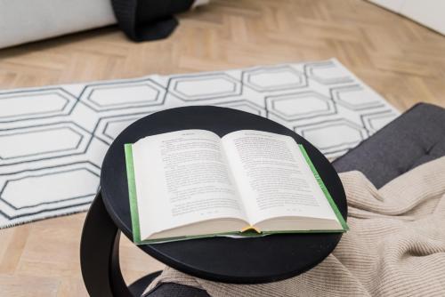 a book sitting on a table next to a keyboard at Explore the City from Its Center in a Chic Balcony Apartment in Bucharest
