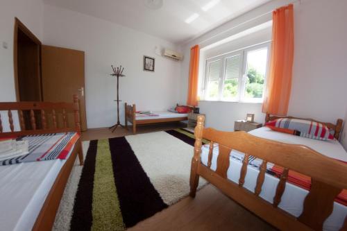 a bedroom with two beds and a window at Hostel -Sema in Mostar