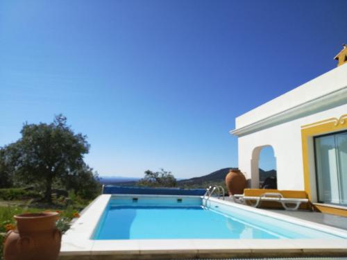 a swimming pool in front of a house at Casa da Paleta in Castelo de Vide