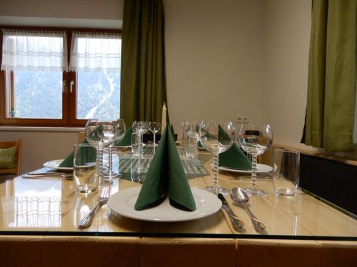 a table with wine glasses and green napkins on it at Mottnerhof in Braz