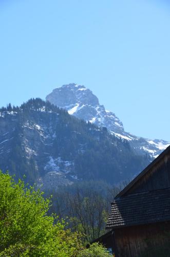 a snow covered mountain in front of a house at Mottnerhof in Braz