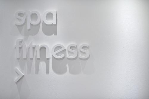 a white door with a sign that says so much kindness at Link124 Hotel in Parma