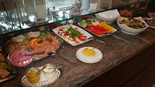 a buffet with many different types of food on a counter at Hotel Am Kloster in Wienhausen