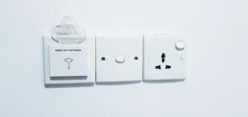 two white wii controllers sitting next to each other at Breeze Guest House in Trincomalee