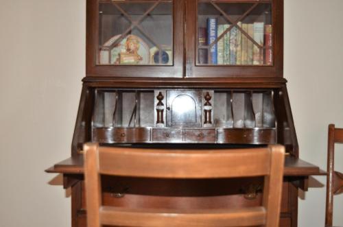 a wooden cabinet with a table and a chair at Little River Inn Motel in Leon